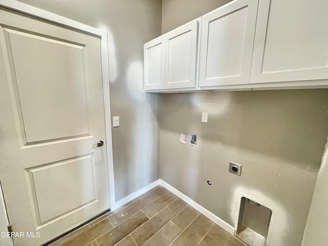 clothes washing area featuring hookup for a washing machine, cabinets, and electric dryer hookup