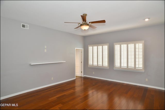 unfurnished room featuring ceiling fan and dark wood-type flooring