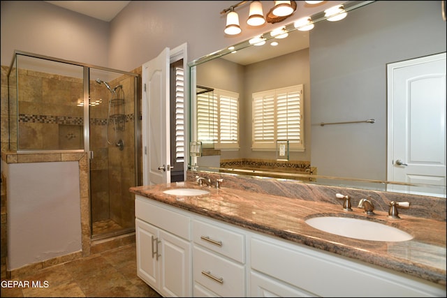 bathroom featuring vanity and a shower with door