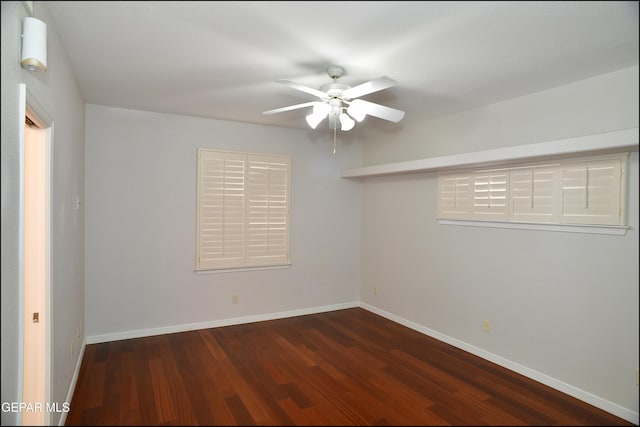 spare room with ceiling fan and dark wood-type flooring