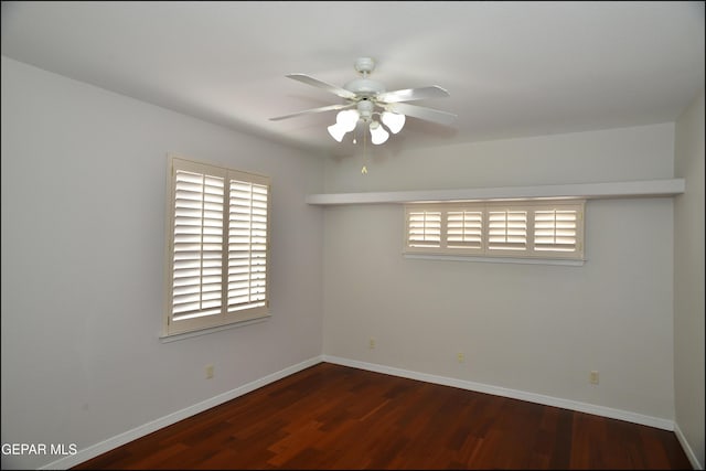 unfurnished room with ceiling fan and dark wood-type flooring