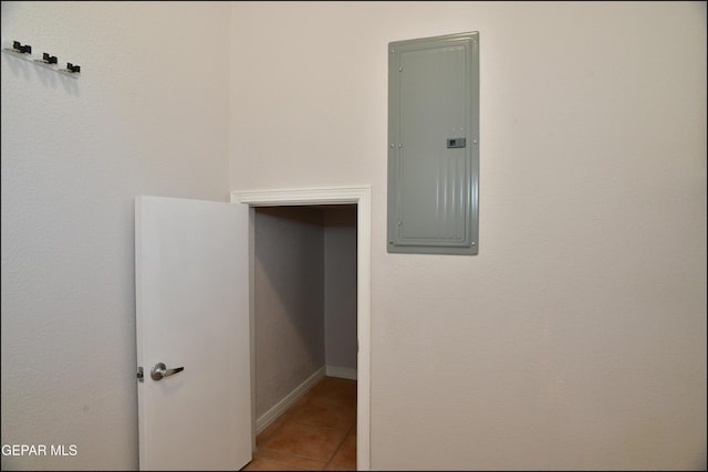 interior space with electric panel and light tile patterned flooring