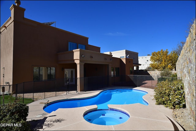 view of pool featuring a patio area and an in ground hot tub