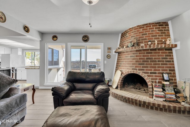 living room with light hardwood / wood-style floors and a fireplace