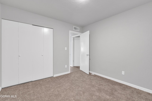 unfurnished bedroom featuring a closet and carpet