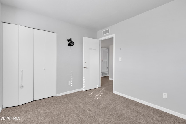 unfurnished bedroom featuring a closet and carpet floors