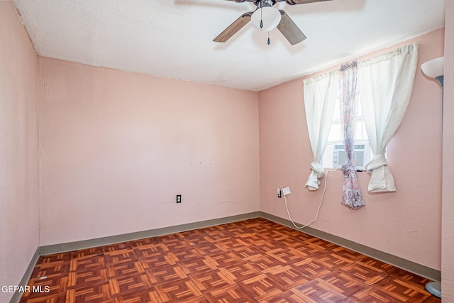 unfurnished room with ceiling fan, dark parquet floors, cooling unit, and a textured ceiling