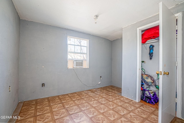 unfurnished room featuring cooling unit