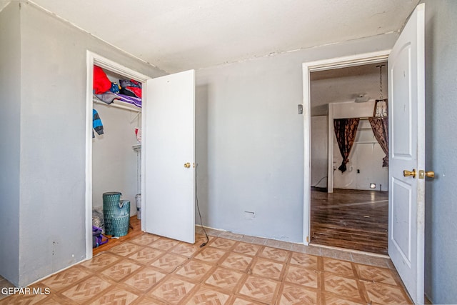 unfurnished bedroom with a closet and light parquet floors