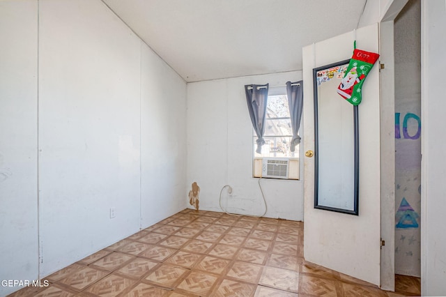 spare room with cooling unit and light parquet flooring