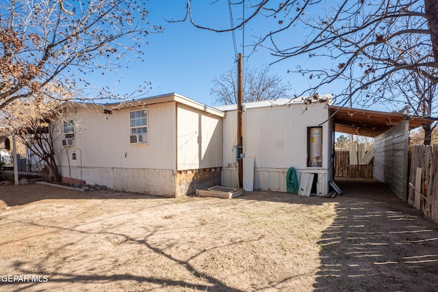 rear view of property with a carport