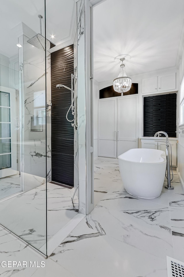 bathroom with an inviting chandelier and shower with separate bathtub