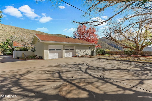 view of front of property with a mountain view and a garage