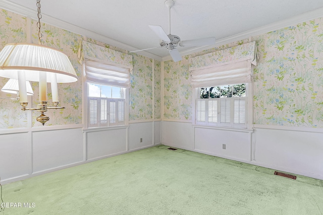 interior space featuring ceiling fan, carpet floors, and crown molding