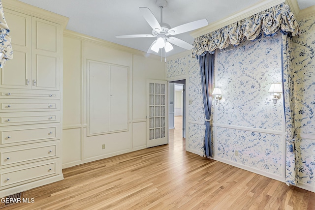 unfurnished bedroom with a closet, light hardwood / wood-style floors, ceiling fan, and crown molding