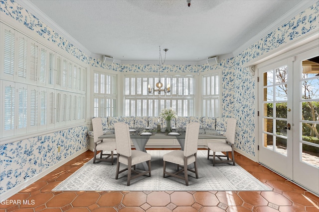 sunroom / solarium featuring french doors and an inviting chandelier