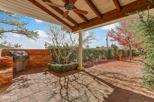 view of patio / terrace with area for grilling, ceiling fan, and an outdoor kitchen