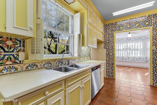 kitchen with pendant lighting, a healthy amount of sunlight, sink, and stainless steel dishwasher