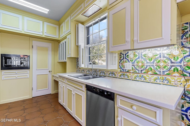 kitchen with dishwasher, dark tile patterned flooring, and sink