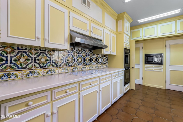 kitchen featuring dark tile patterned floors and black appliances