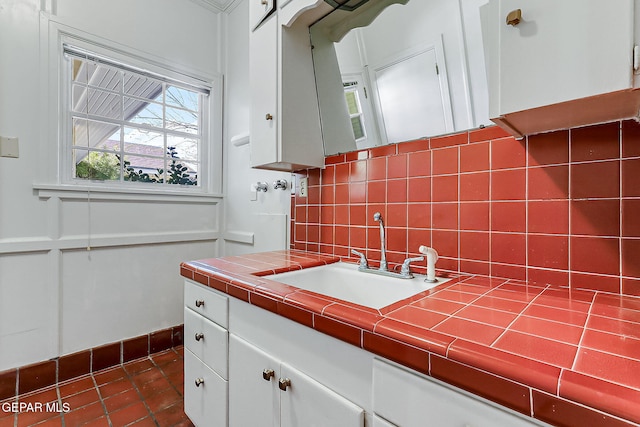 bathroom featuring vanity, backsplash, and tile patterned floors