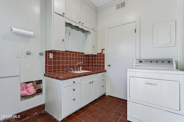 laundry area with cabinets, electric panel, sink, crown molding, and washer / clothes dryer