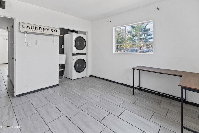 laundry area with stacked washer / dryer