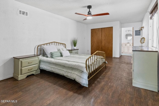 bedroom featuring a closet, ceiling fan, dark wood-type flooring, and sink