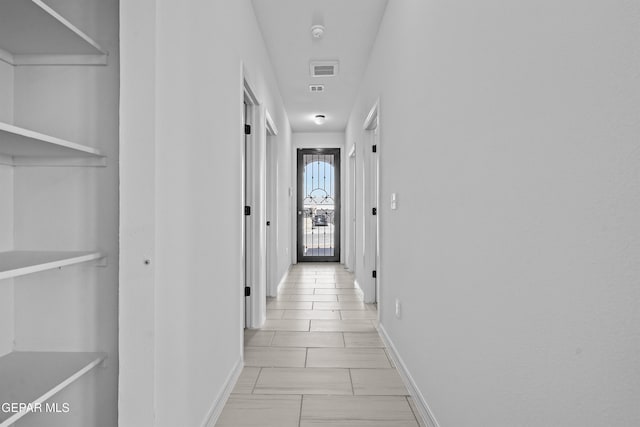 hallway with light tile patterned flooring