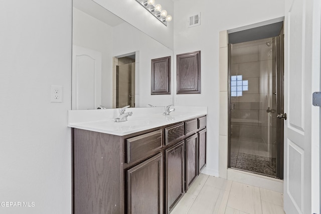 bathroom with vanity, tile patterned floors, and a shower with shower door