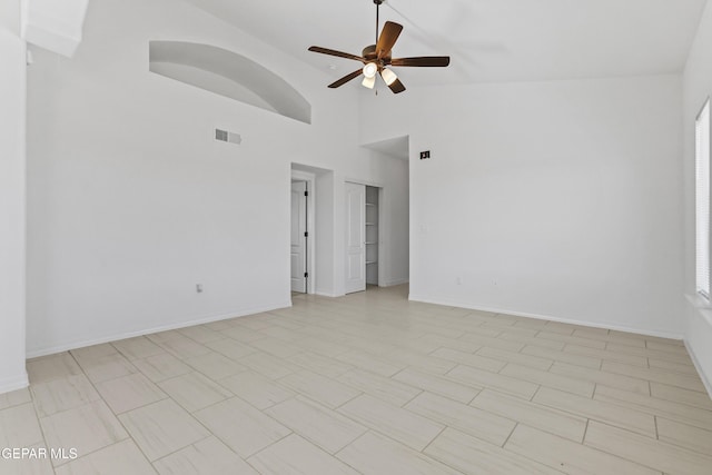 unfurnished room featuring ceiling fan, light tile patterned floors, and high vaulted ceiling