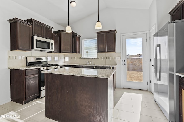 kitchen featuring a wealth of natural light, stainless steel appliances, vaulted ceiling, and hanging light fixtures