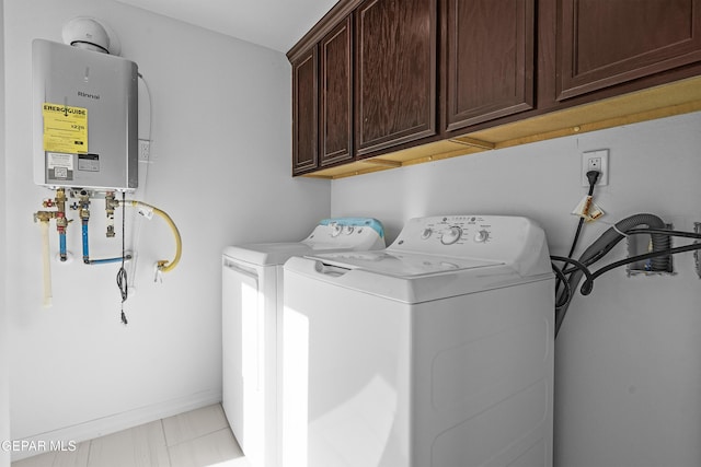 laundry area featuring tankless water heater, cabinets, and independent washer and dryer