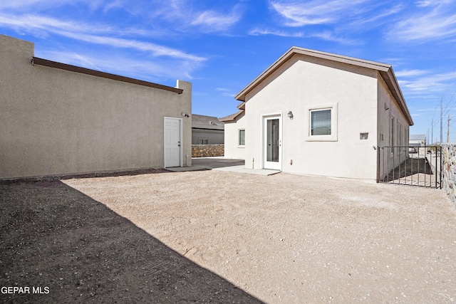 back of house with a patio