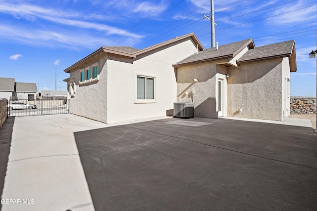 back of property with a patio and central AC unit