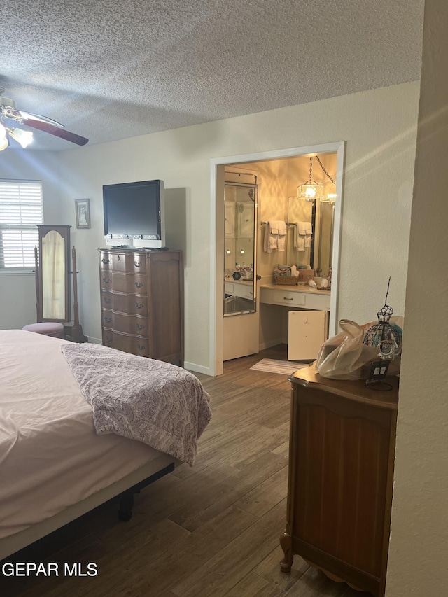 bedroom with dark hardwood / wood-style flooring, a textured ceiling, and ceiling fan