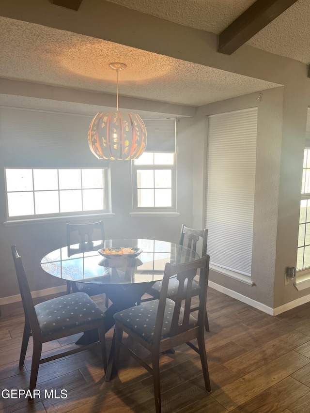 dining room featuring beamed ceiling, a textured ceiling, a chandelier, and dark hardwood / wood-style floors