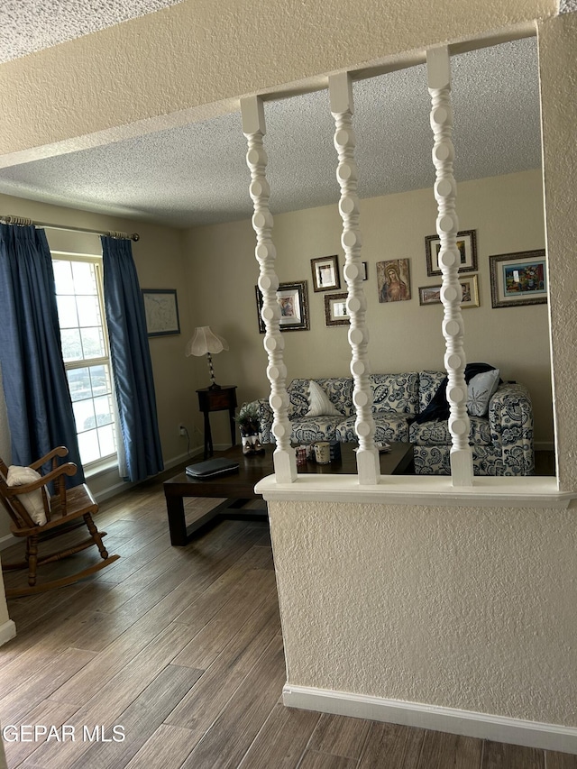 living room featuring a textured ceiling and hardwood / wood-style flooring