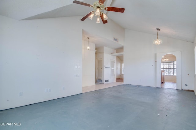 spare room featuring ceiling fan with notable chandelier and vaulted ceiling