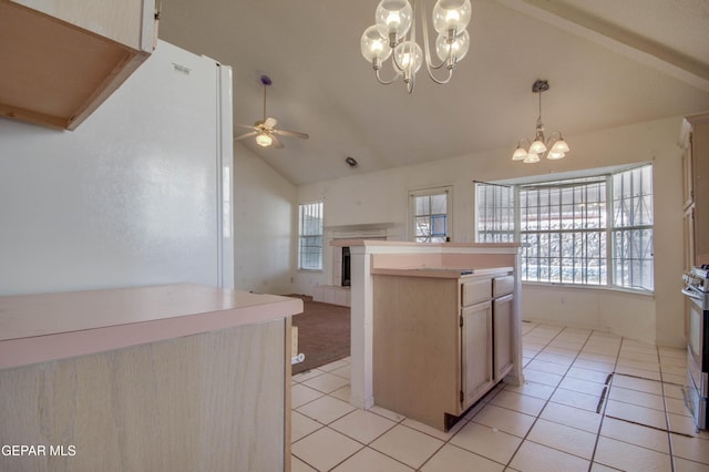 kitchen featuring lofted ceiling, ceiling fan with notable chandelier, light brown cabinetry, decorative light fixtures, and light tile patterned flooring