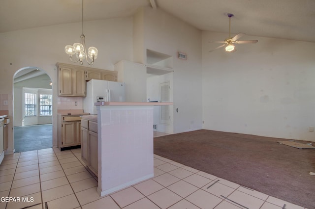 kitchen with a center island, high vaulted ceiling, ceiling fan with notable chandelier, white fridge with ice dispenser, and light tile patterned floors