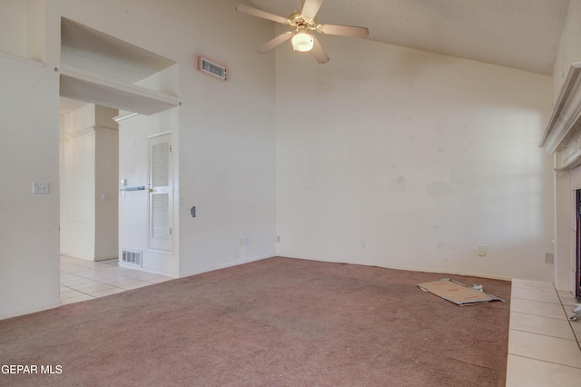 carpeted empty room featuring ceiling fan and lofted ceiling