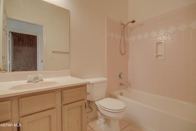 full bathroom featuring tile patterned flooring, vanity, toilet, and tiled shower / bath