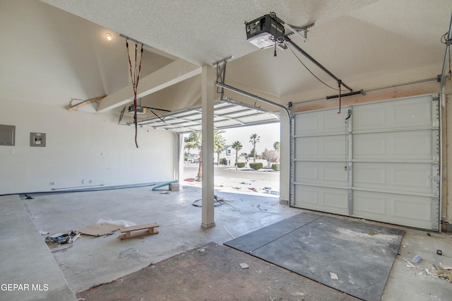 garage featuring electric panel and a garage door opener