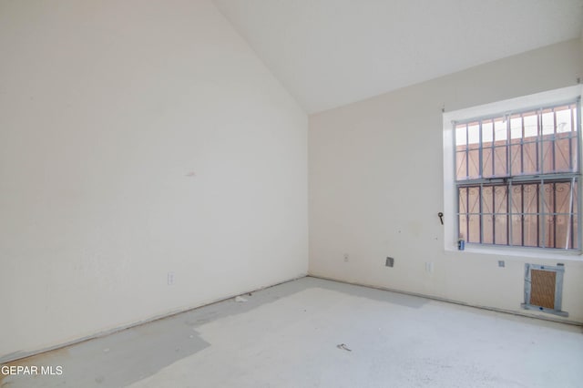 empty room featuring lofted ceiling