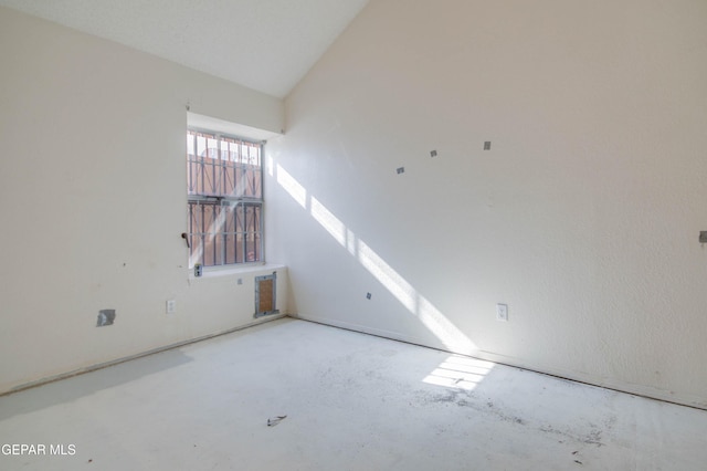 spare room featuring vaulted ceiling