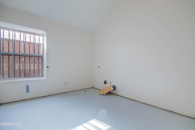 empty room featuring lofted ceiling