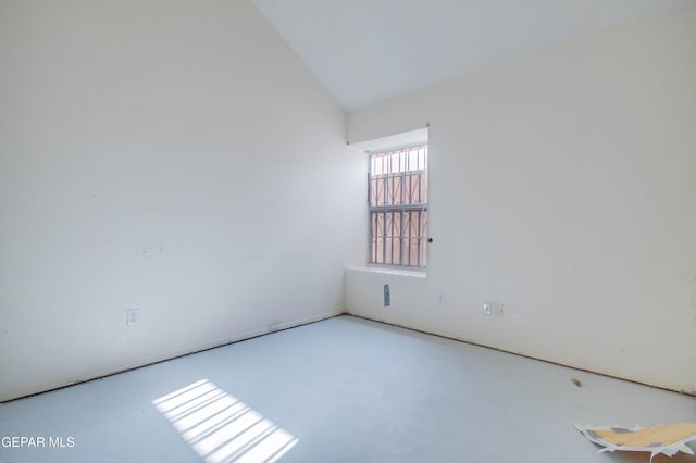 spare room with lofted ceiling