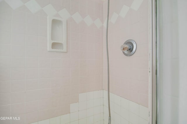 bathroom with a tile shower