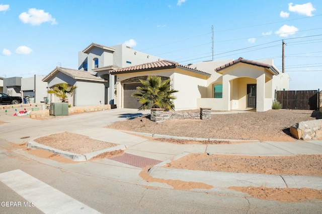 mediterranean / spanish-style home with a garage